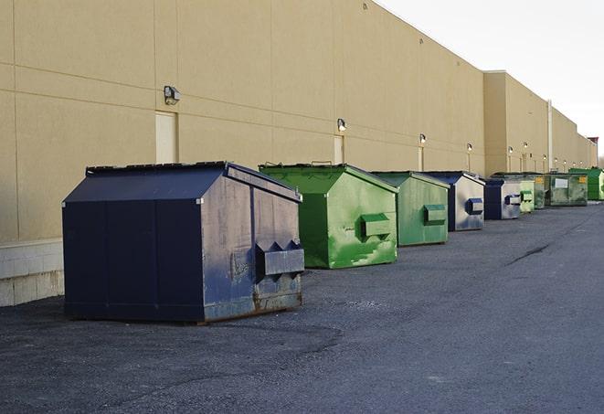 a row of industrial dumpsters at a construction site in Baldwin City, KS